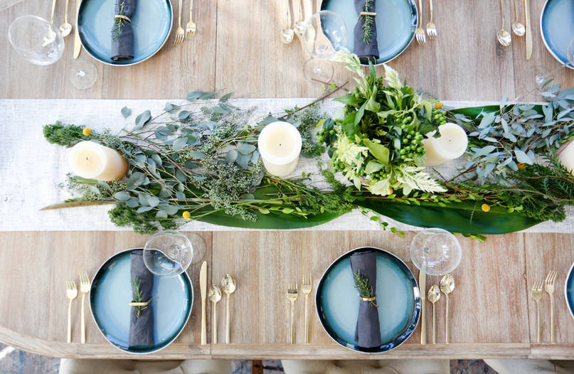 Thanksgiving table with fresh greens on a tablerunner
