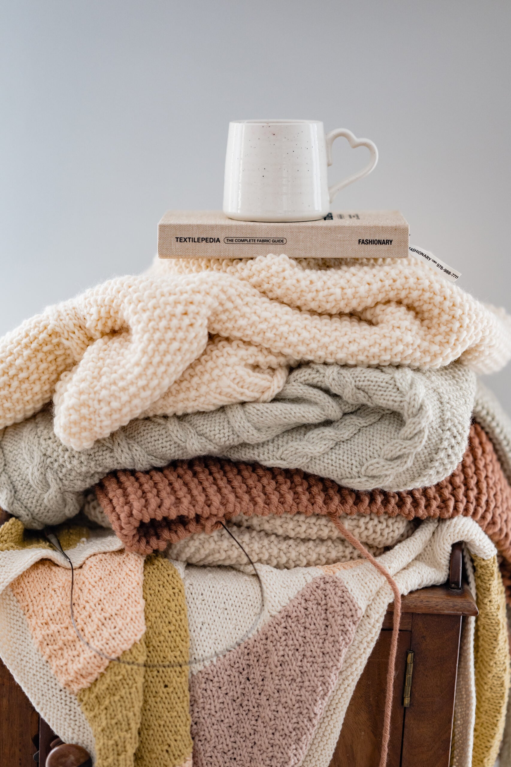 Stack of knitting projects