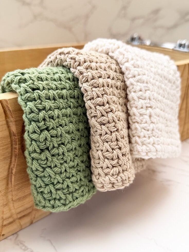 farmhouse crochet dishcloth folded over a wooden box