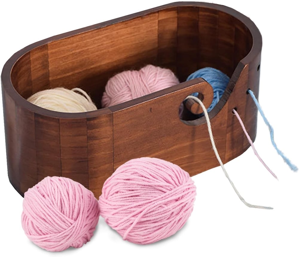 wooden yarn bowl and pink yarn